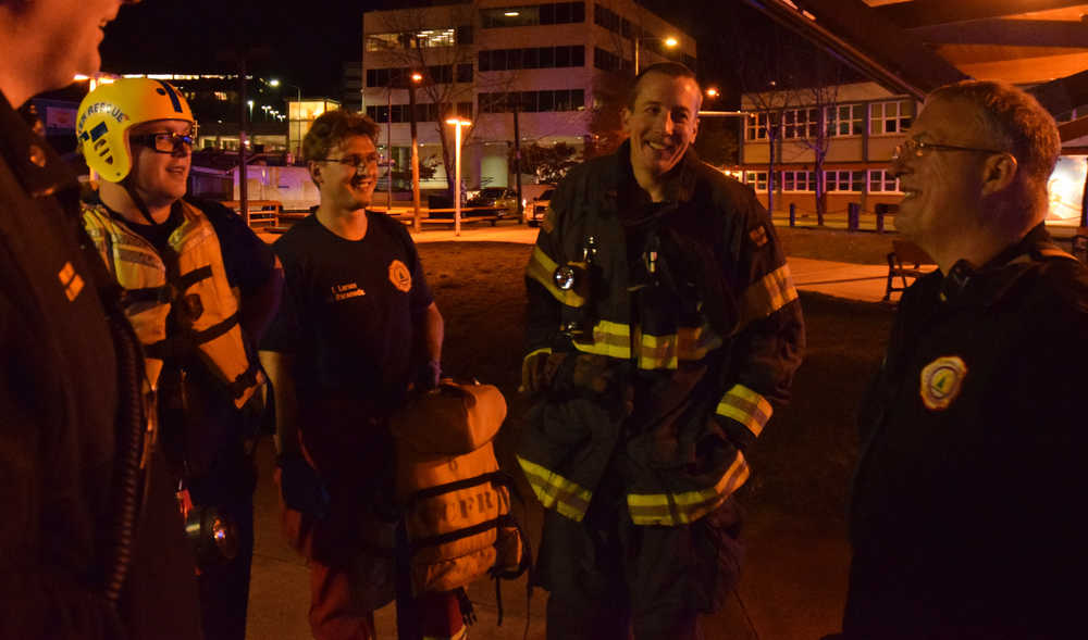 Firefighter Noah Jenkins, second from right, was the person who jumped in the water off the Alaska Steamship Dock on Tuesday evening, Oct. 6, 2015 in downtown Juneau to rescue a man who had fallen from the dock above.
