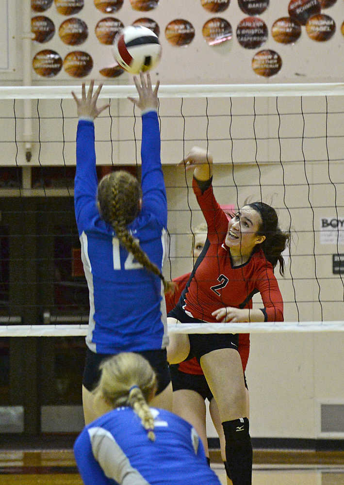 Juneau-Douglas' Martina Worden (2) kills a shot past Thunder Mountain's Audrey Welling (12) during the Crimson Bears 25-13, 25-17, 25-12 win over the Falcons on Tuesday at JDHS.
