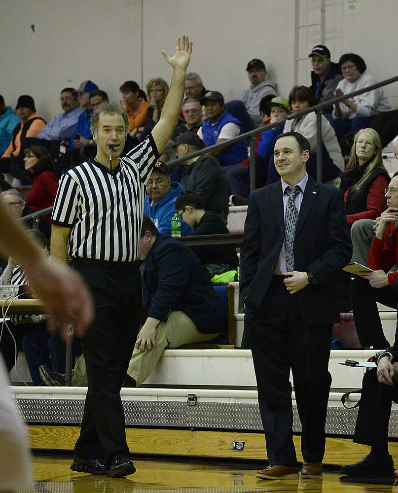 Referee Joel Osburn enjoys a light moment with Juneau-Douglas coach Robert Casperson during action last season.