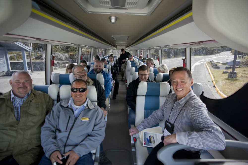 Dennis McDonnell, President of Alaska Coach Tours, right, and other attending the Alaska Travel Industry Association's Annual Convention & Trade Show ride an electric motor coach provided by BYD Auto Co., Ltd., a Chinese automobile manufacturer based in Shenzhen, Guangdong Province, to the Mendenhall Glacier Visitors Center to showcase the potential for electric vehicle bus transportation as part of the tourism industry in Alaska on Tuesday.