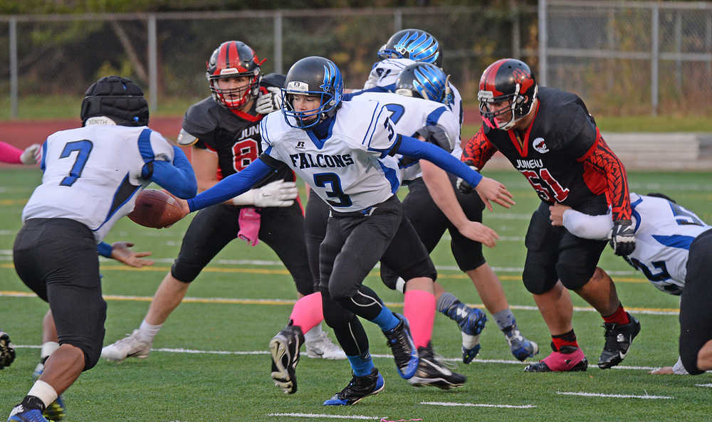 Thunder Mountain's Cale Jenkins (3) hands off to senior running back Q'on Bear-Clark (7) during the Glacier Bowl. TMHS defeated JDHS to earn a state playoff semifinal game against Soldotna on Saturday at Anchorage's Dimond High School Alumni Field.