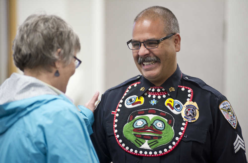 Juneau Police Department Sgt. Chris Burke is congratulated by Juneau City Manager Kim Kiefer during the department's Quarterly Awards Ceremony on Thursday. Sgt. Burke received a Purple Heart Award and a Medal of Valor for an arrest made at the Juneau International Airport.