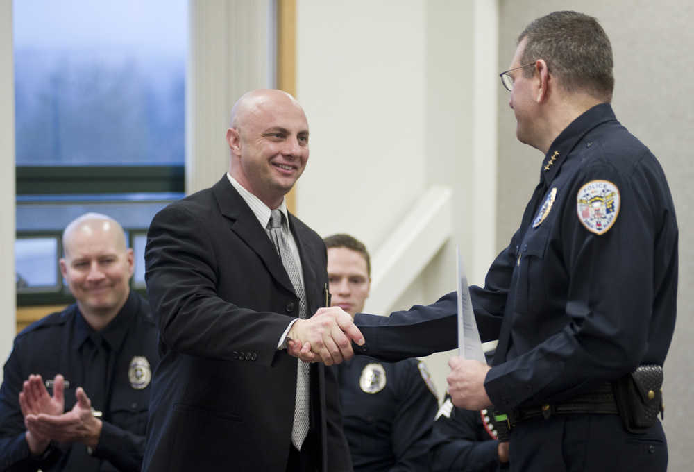 Daniel Darbonne, left, is congratulated by Juneau Police Chief Bryce Johnson after being sworn in as a new officer on Thursday.