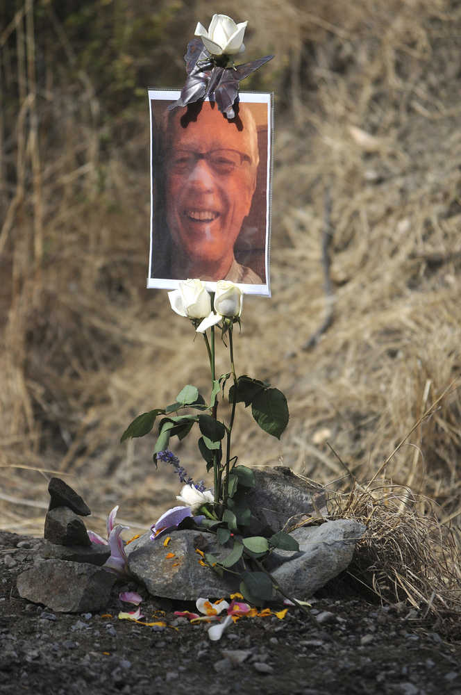 In this photo taken Wednesday Oct. 7, 2015, Lokita Carter and friends put this small shrine together in Fairfax, Calif., at the site where her husband Steve was found apparently shot to death near Fairfax, Calif. Authorities said Thursday, Oct. 8, 2015, that they recovered the gun thought to be the one used to kill the popular tantra yoga teacher when they arrested three drifters in Oregon traveling in the victim's car. The three young suspects will be extradited to California after investigators tracked them from the homicide scene from a scenic hiking trail 20 miles north of San Francisco to a community dining hall 600 miles away in Portland, Oregon.  (Frankie Frost/Marin Independent Journal via AP)