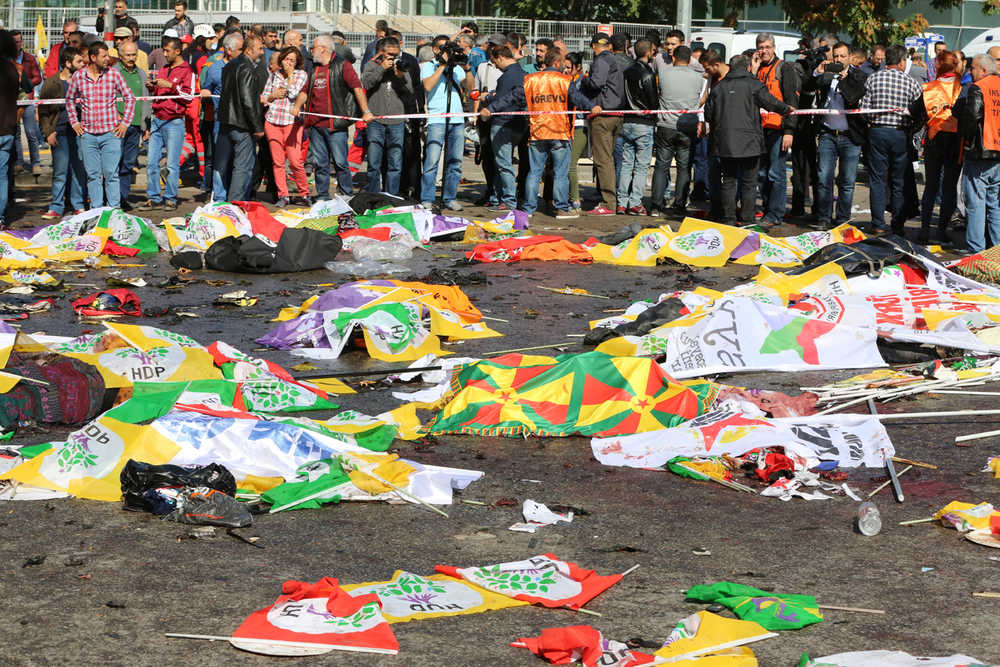 Bodies of victims are covered with flags and banners at the site of an explosion in Ankara, Turkey on Saturday.