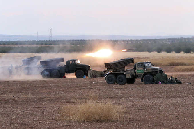 In this photo taken on Wednesday, Syrian army rocket launchers fire near the village of Morek in Syria.