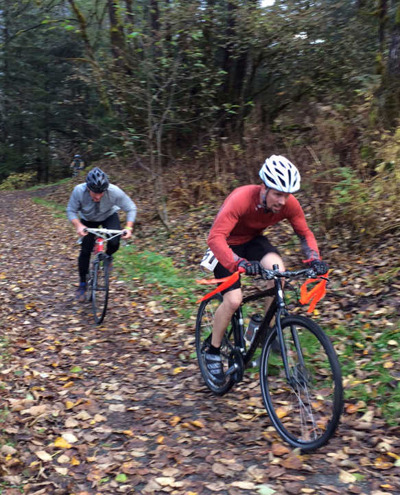 Ken Steck and Collin Wigfield-Gorka work a short climb between the lower and upper Treadwell Mines Trails during the Cyclocross race on Saturday.