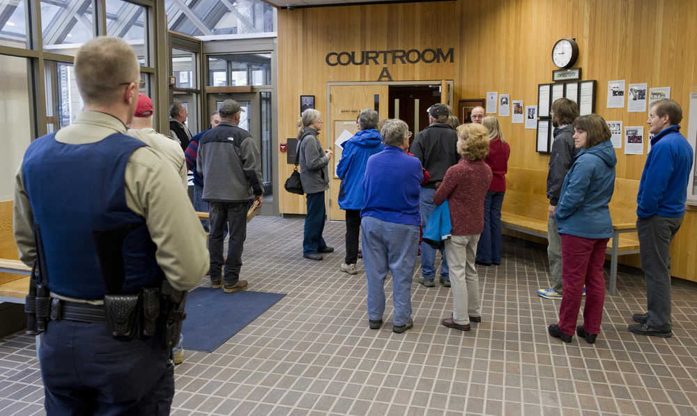People interested in a civil lawsuit by trapper John Forrest against Kathleen Turley wait outside Juneau District Court Monday morning.