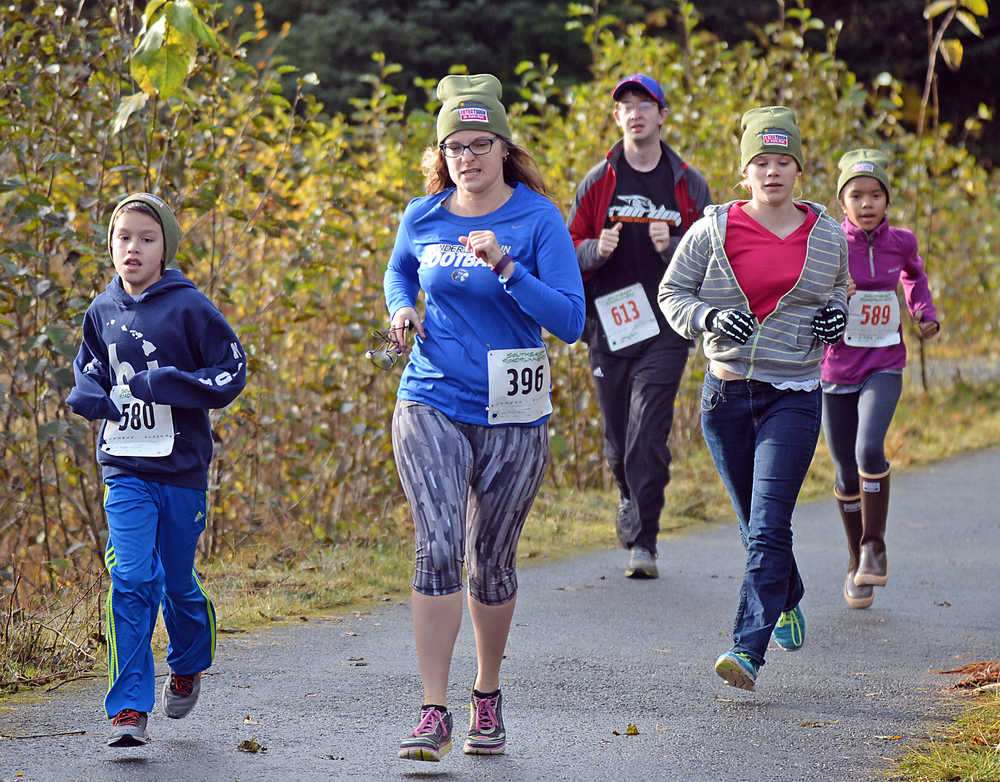 Runners move along a portion of the Kaxdigoowu Heen Dei (Mendenhall River Trail) near Riverbend Elementary School and Thunder Mountain High School during the Extra Tough 5K and 1-Mile run/walk. The race was a fundraiser for NAMI Juneau. A slideshow of photos is online at juneauempire.com.