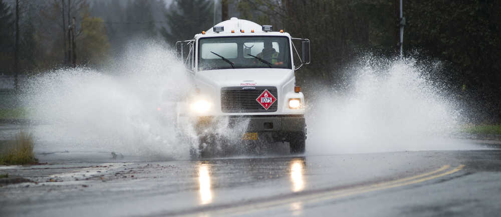 A delivery truck splashes through flooding on Riverside Drive near Melvin Park on Tuesday. The National Weather Service forecast for Wednesday calls for mostly cloudy with a chance of rain showers. Highs around 50. Southeast wind 10 mph.