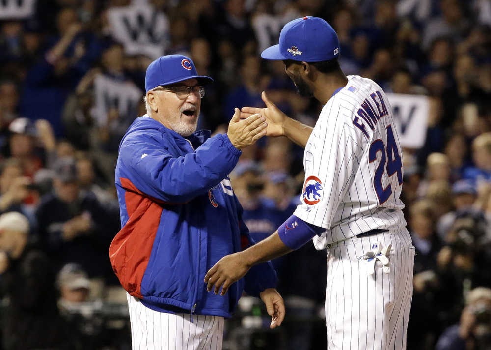 Chicago Cubs manager Joe Maddon celebrates with Dexter Fowler (24) after winning Game 4 in baseball's National League Division Series against the St. Louis Cardinals, Tuesday, Oct. 13, 2015, in Chicago. The Cubs won 6-4. (AP Photo/Nam Y. Huh)