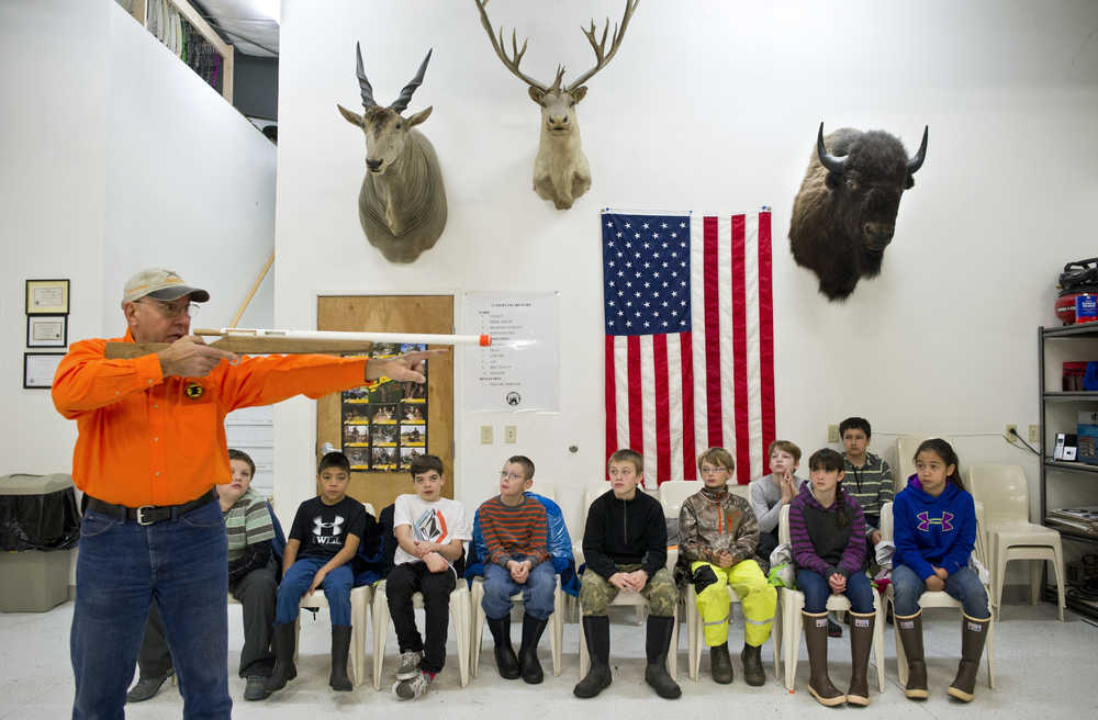 Frank Zmuda gives Floyd Dryden Middle School sixth-grade students a lesson in holding a rifle at the Hunter Education Indoor Training Center as part of their Outdoor Skills class on Wednesday. Volunteers assisting in teaching Juneau sixth-graders are from the Alaska Department of Fish & Game, U.S. Coast Guard, Taku River Sportman's Associaton and the U.S. Forest Service.