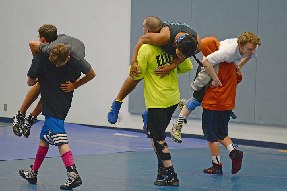 Thunder Mountain High School wrestlers warm up during Falcons practice on Wednesday. TMHS and Juneau-Douglas compete at Wrangell this weekend.