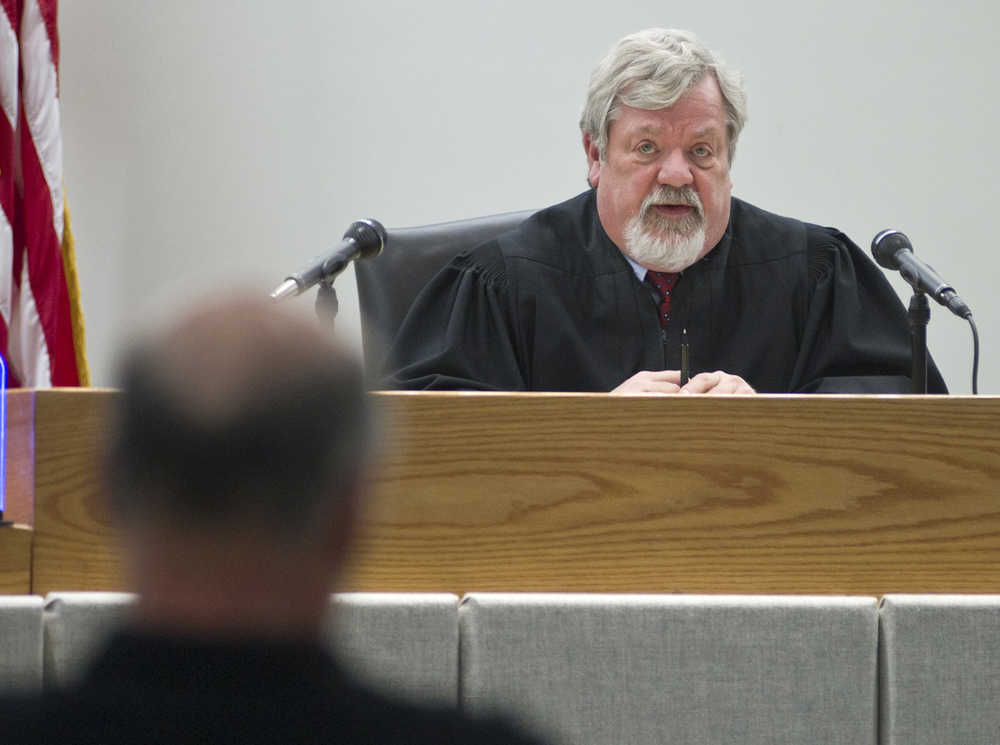 Juneau District Court Judge Thomas Nave speaks to John Forrest after closing statements in Forrest's lawsuit against Kathleen Turley for springing his traps on the Davies Creek trail in December. Judge Nave is to issue a judgment by noon on Friday.