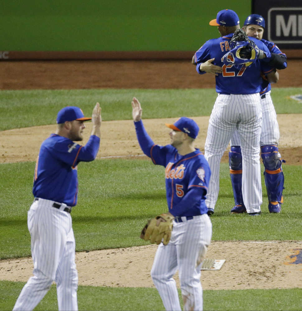 New York Mets catcher Travis d'Arnaud hugs Jeurys Familia (27) after Game 1 of the National League baseball championship series against the Chicago Cubs Saturday, Oct. 17, 2015, in New York. The Mets won 4-2 to take a 1-0 lead in the series. (AP Photo/David Goldman)