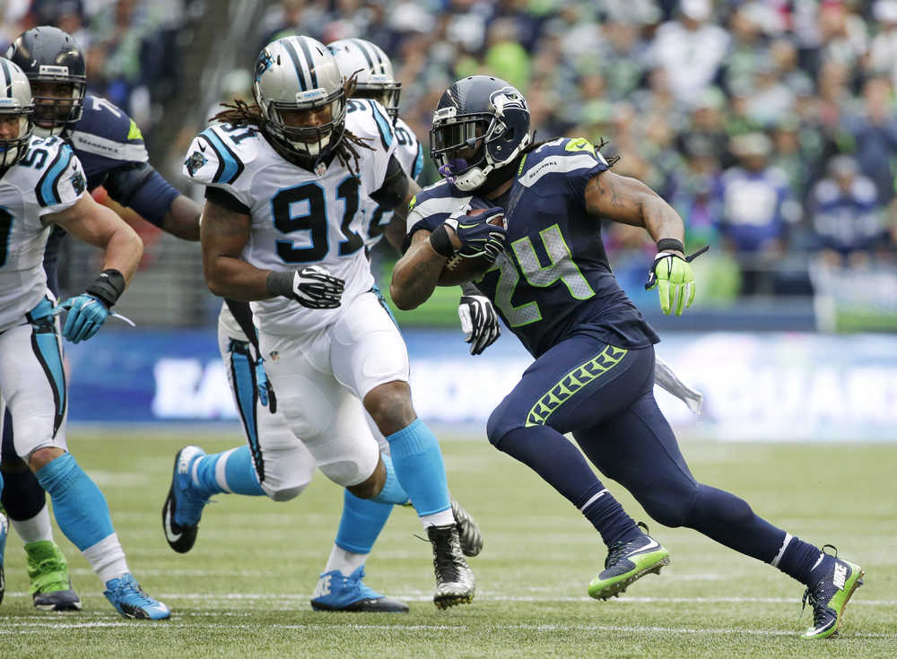 Seattle Seahawks running back Marshawn Lynch rushes against Carolina Panthers' Ryan Delaire (91) in the second half of an NFL football game, Sunday, Oct. 18, 2015, in Seattle. (AP Photo/Elaine Thompson)