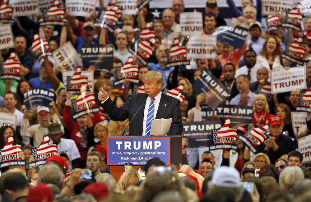 In this Oct. 14 photo, Republican presidential hopeful Donald Trump gestures during a speech to supporters at a rally in Richmond, Virginia. Trump has long boasted about his enormous wealth and how he doesn't need anyone else's money to fund his presidential campaign. But that hasn't stopped tens of thousands of people from across the country from chipping in with small-dollar checks as small as $10 or $25 to let him know that they're behind him.