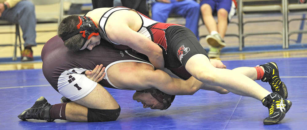 In this November 2013 photo, Ketchikan's Nate Fousel and Juneau-Douglas' Cody Weldon grapple at the Brandon Pilot Invitational. Weldon defeated Fousel, a 2014 state champ. on Saturday in Wrangell.