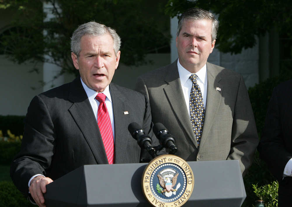 FILE - In this April 19, 2006 file photo, President George W. Bush, accompanied by his brother, then-Fla. Gov. Jeb Bush, speaks on the South Lawn at the White House in Washington. Jeb Bush is tossing aside any hesitations about embracing former President George W. Bush's legacy and is searching for new ways to incorporate him into his White House campaign.  (AP Photo/Ron Edmonds, File)
