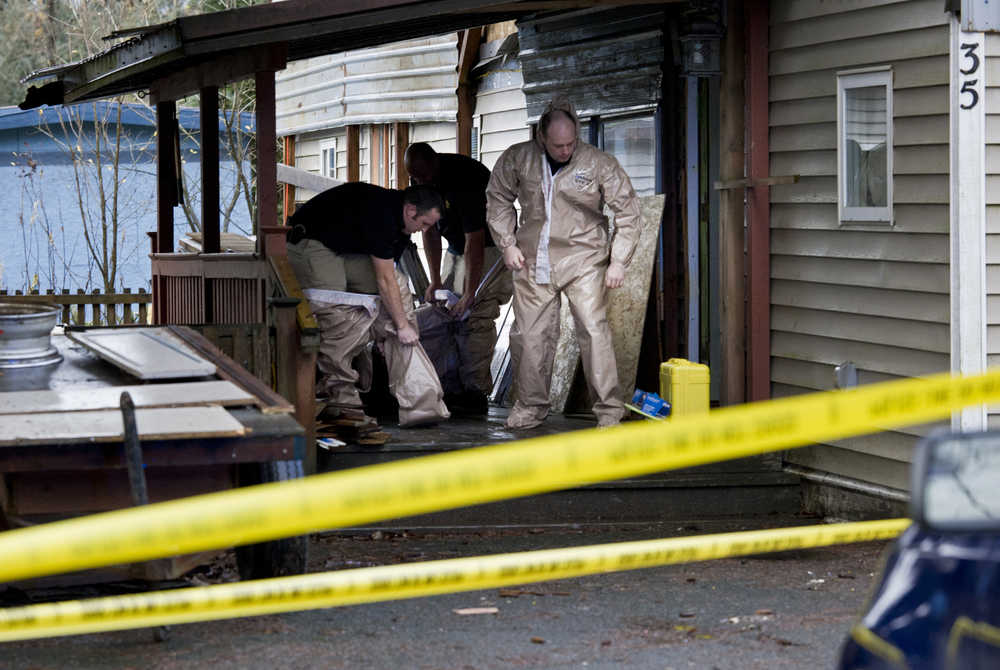 Juneau Police Department detectives prepare to enter unit 35 in the Glacierview Trailer Park on Wednesday where a 32-year-old suspect involved in the shooting death of a 30-year-old man was arrested Tuesday night.