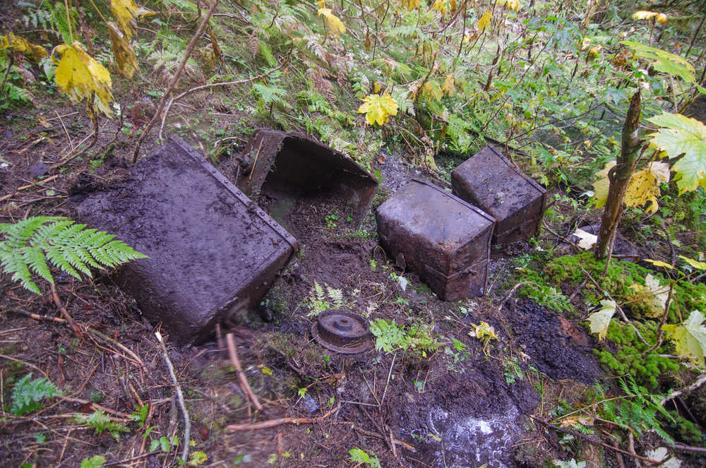 Small ore buckets lie strewn around the Amalga mill site.