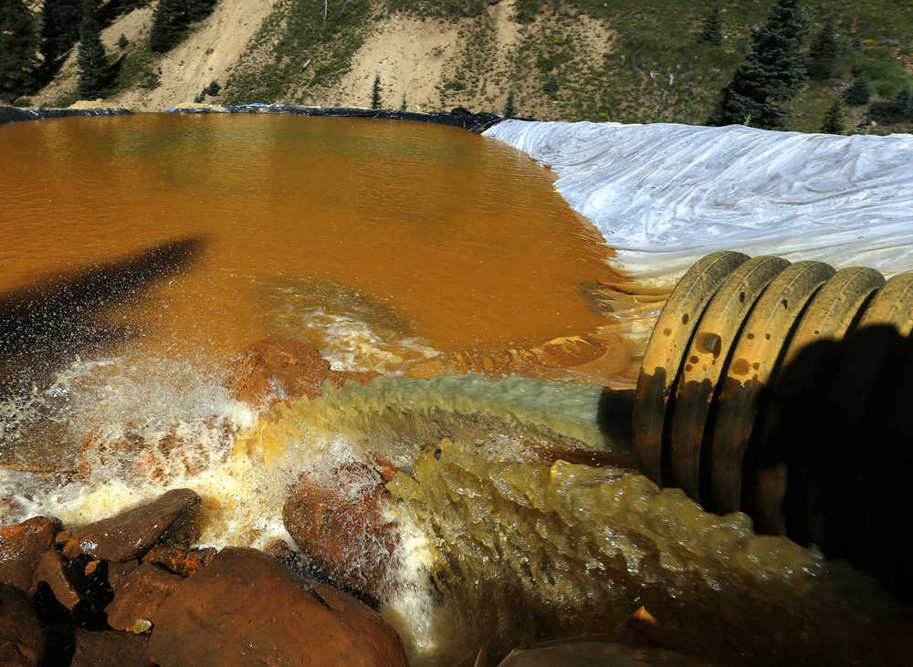 FILE - In this Aug. 14, 2015 file photo, water flows through a series of retention ponds built to contain and filter out heavy metals and chemicals from the Gold King mine chemical accident, in the spillway about 1/4 mile downstream from the mine, outside Silverton, Colo. A temporary treatment plant, not pictured, has begun cleaning up polluted water flowing from the Gold King Mine in southwestern Colorado after an accident sent millions of gallons of waste into rivers in three states. The Environmental Protection Agency said Monday, Oct. 19, 2015 that the $1.8 million plant is processing up to 800 gallons per minute, including water flowing from the mine and water stored in ponds. (AP Photo/Brennan Linsley, file)