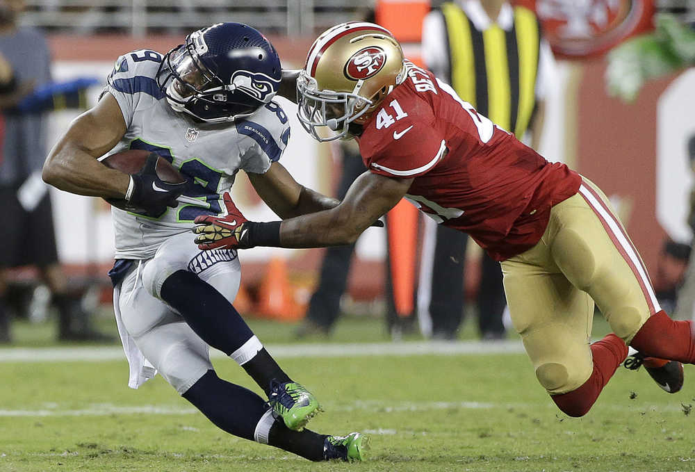San Francisco 49ers strong safety Antoine Bethea (41) tackles Seattle Seahawks wide receiver Doug Baldwin (89) during the first half of an NFL football game in Santa Clara, Calif., Thursday, Oct. 22, 2015. (AP Photo/Marcio Jose Sanchez)