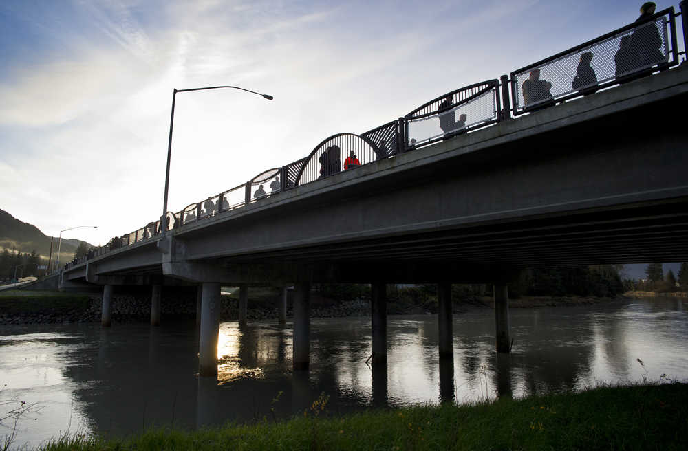 People walk across Brotherhood Bridge for a rededication ceremony on Saturday.