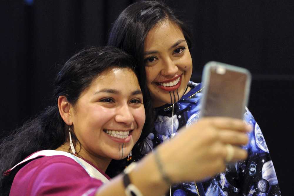 In this photo taken on Oct. 13, Marjorie Tahbone of Nome, left, and Denali Whiting, of Kotzebue, take a selfie during the First Alaskans Institute Elders and Youth Conference in Anchorage.
