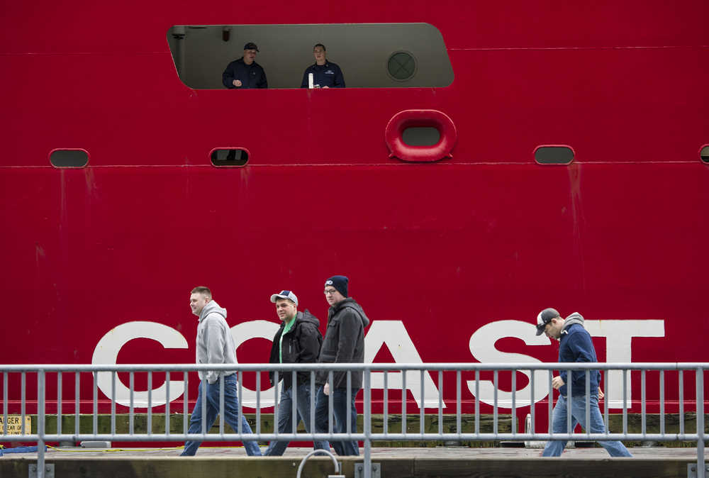 Some of the crew of the polar icebreaker U.S. Coast Guard Cutter Healy head to downtown Juneau as others stand watch on Friday. The ship stopped in Juneau during a return trip to it's Seattle base after it's Arctic West Summer 2015 science mission.