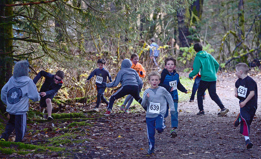 Runners scramble as zombies attack during Sunday's 4th Annual Zombie Run 5K or 1-mile run on the Treadwell Trails at Sandy Beach. The event was a fundraiser for the Harborview Elementary Triathlon Club.