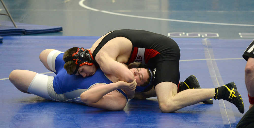 Juneau-Douglas' Cody Weldon tries to pin Thunder Mountain's Devin Locke during home wrestling action last week. The Crimson Bears and Falcons will travel to the Bill Weiss Invitational this weekend at Ketchikan.