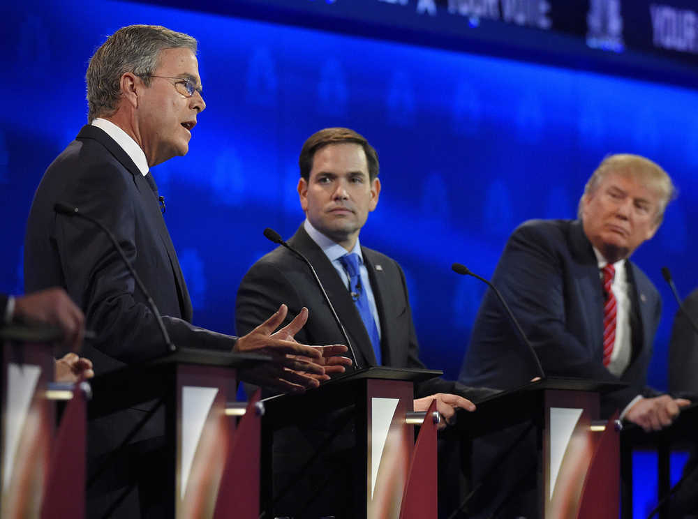 Marco Rubio, center, and Jeb Bush, left, argue a point as Donald Trump looks on during the CNBC Republican presidential debate at the University of Colorado, Wednesday, Oct. 28, 2015, in Boulder, Colo. (AP Photo/Mark J. Terrill)