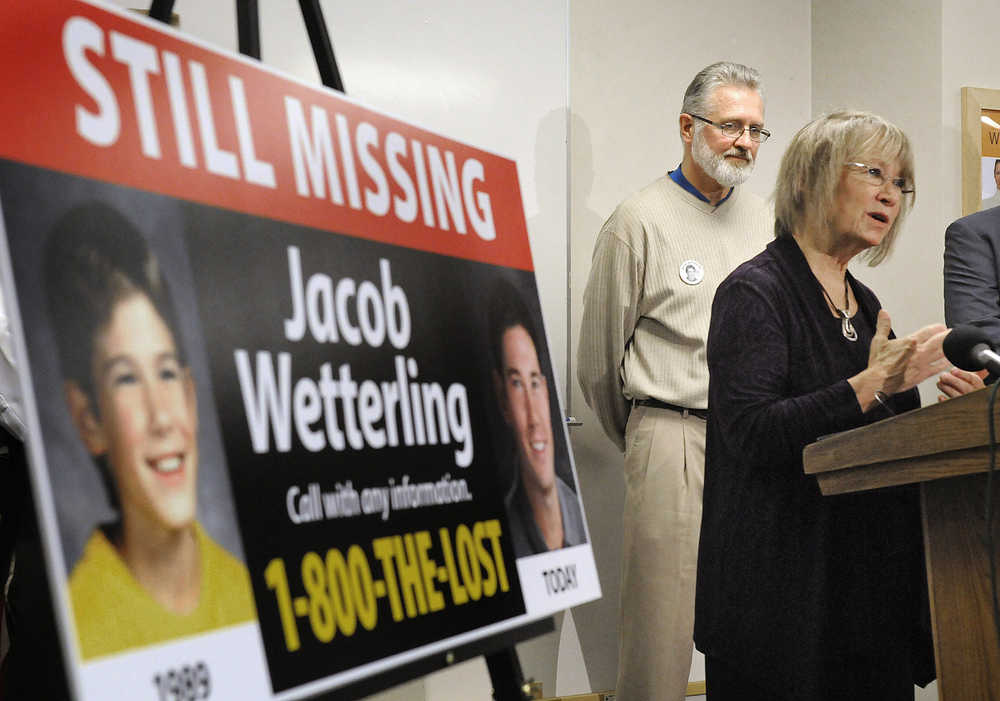 FILE - In this Oct. 14, 2014 file photo, Patty, right, and Jerry Wetterling take part in a news conference at the Stearns County Law Enforcement Center in St. Cloud, Minn., to announce the installation of six new billboards that will be placed near where their son Jacob was abducted in 1989. Federal authorities said Thursday, Oct. 29, 2015, Daniel James Heinrich, a Minnesota man charged with child pornography after a search of his home found pictures of naked boys is also a "person of interest" in the disappearance of Jacob Wetterling, whose 1989 abduction led his parents to launch a national center to prevent child exploitation.  (Dave Schwarz/St. Cloud Times via AP, File)  NO SALES; MANDATORY CREDIT
