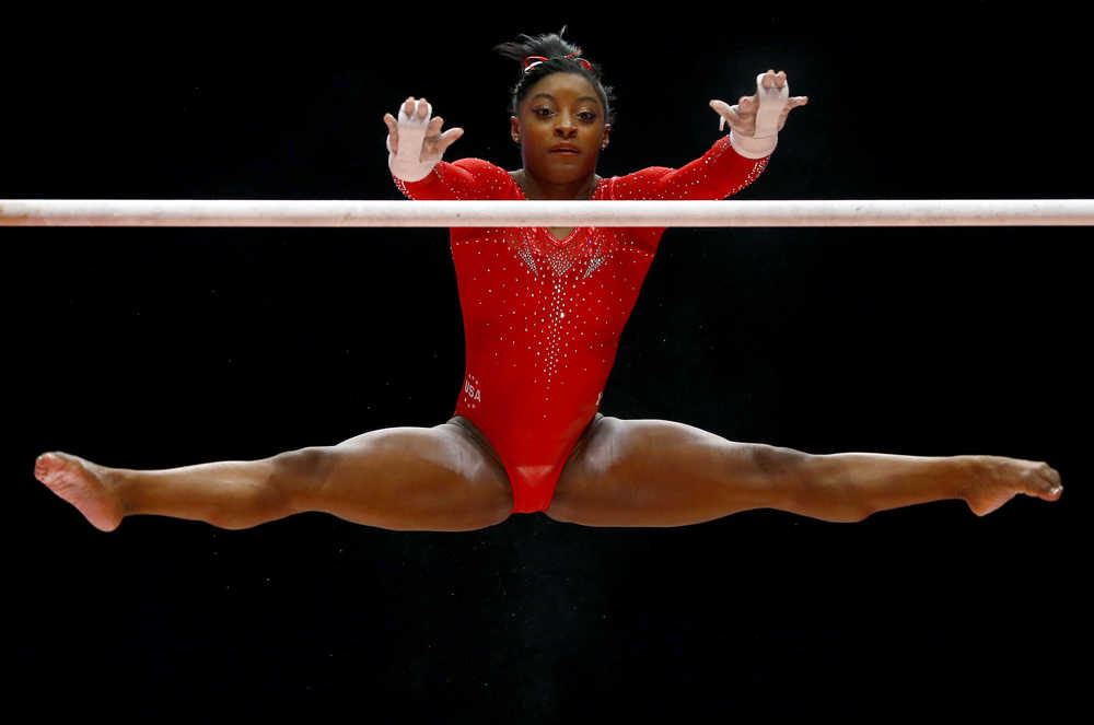 Simone Biles of the U.S. performs on the uneven bars during the women's all-around final competition at the World Artistic Gymnastics championships at the SSE Hydro Arena in Glasgow, Scotland, Thursday, Oct. 29, 2015. (AP Photo/Matthias Schrader)