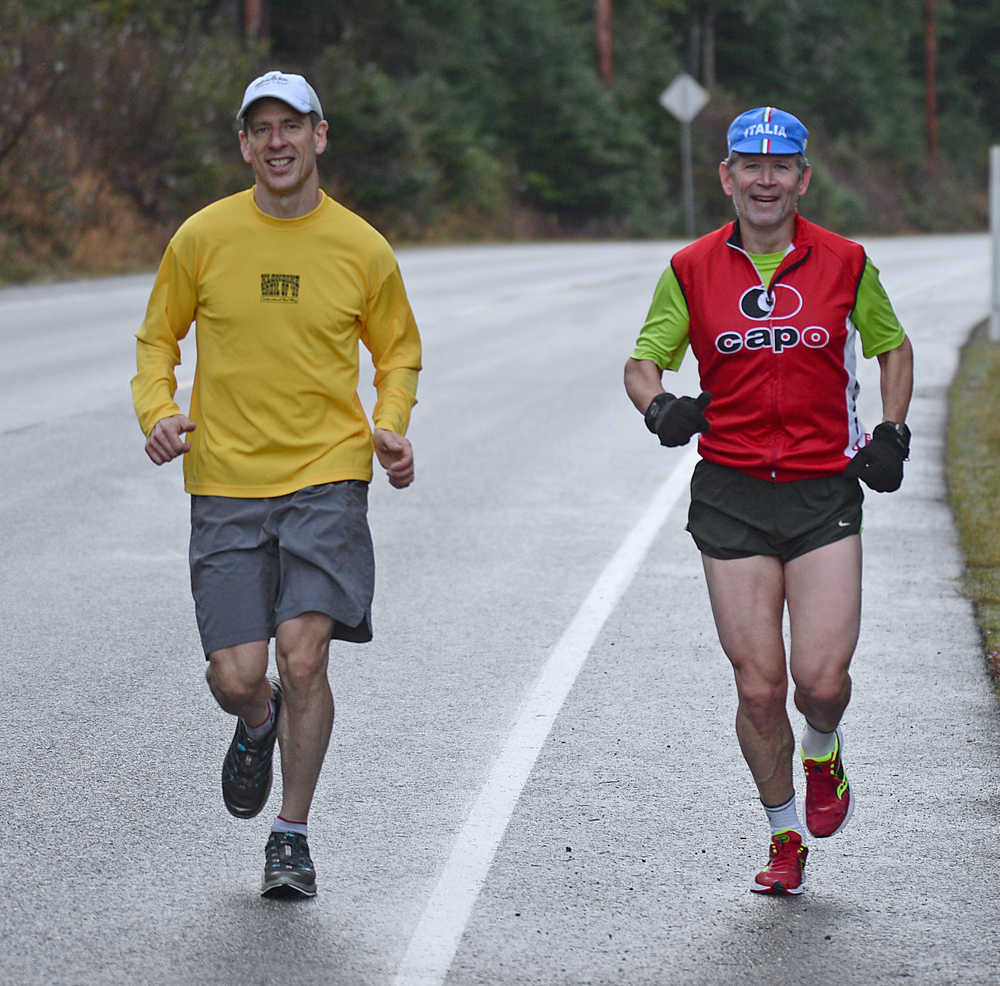 Jim Ustasiewski and John Bursell run along North Douglas Highway on Saturday. Bursell is training for the Boston Marathon on April 18, Patriots' Day in the Commonwealth of Massachusetts. Ustasiewski is just training.