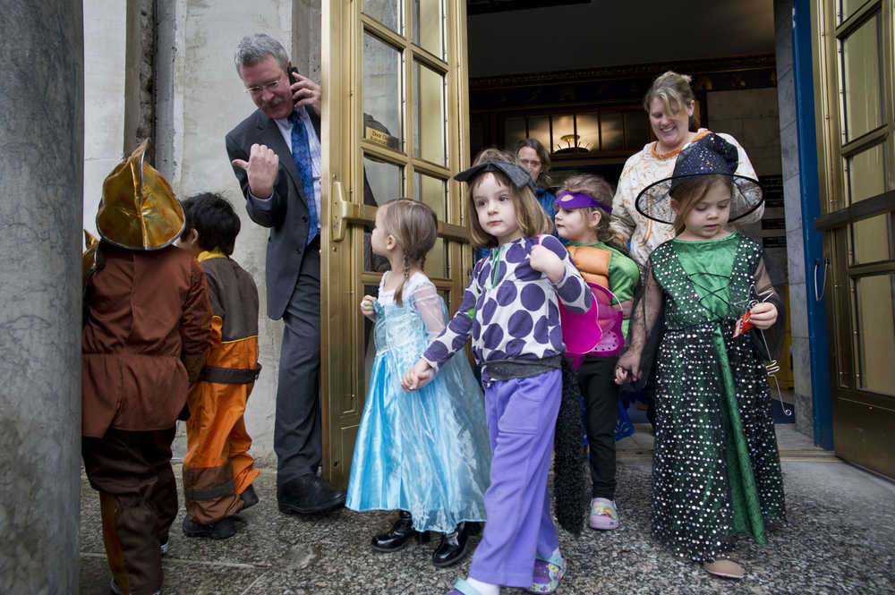 Rep. Dan Saddler, R-Eagle River, takes on door duty for children from the Discovery Preschool during their yearly Halloween costume parade through the Capitol on Friday.