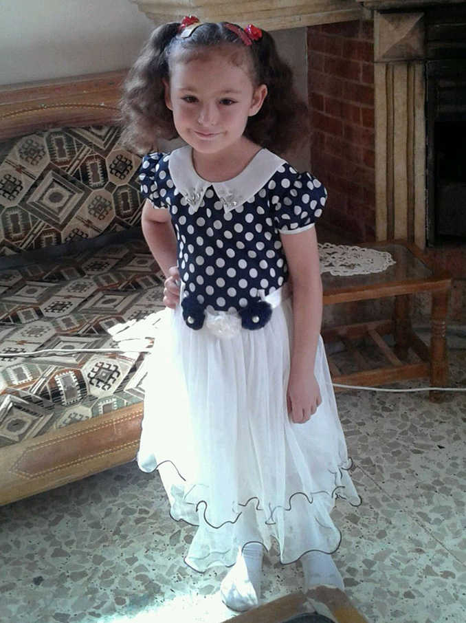 In this picture taken on Oct. 1, Raghad Khanfoura, 4, poses for a picture a few hours before she was killed in a Russian airstrike on her grandparents house in the central Syrian village of Habeet, Syria.