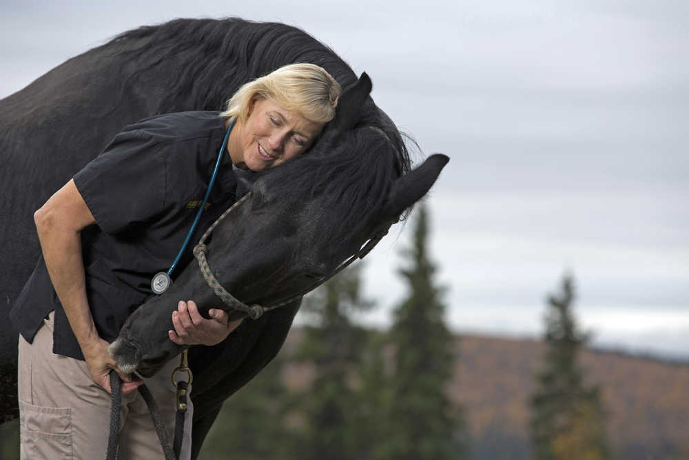 This undated photo provided by Animal Planet shows veterinarian Dr. Dee Thornell with a horse named Thor in Fairbanks, Alaska. She's the star of Animal Planet's "Dr. Dee, Alaska Vet," filmed at her Fairbanks practice, which she calls Animal House, as well as in the wild. The first episode of the show airs on Dec. 7 at 8 p.m. ET/PT.(Animal Planet via AP)