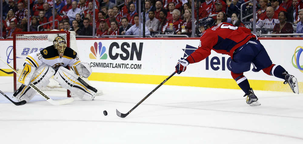 Washington Capitals left wing Alex Ovechkin, right, from Russia, reaches for the puck as Boston Bruins goalie Tuukka Rask (40), from Finland watches during the first period of an NHL hockey game, Thursday, Nov. 5, 2015, in Washington. (AP Photo/Alex Brandon)