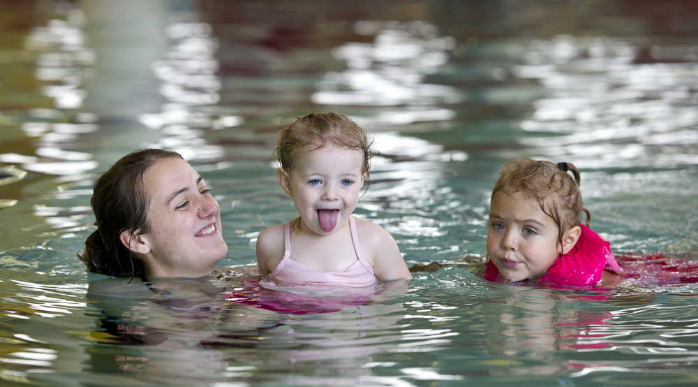 Jennifer Narvaez swims with her daughters, Mary, 2, center, and Margaret, 4, at the Dimond Park Aquatics Center on Thursday, Nov. 5.