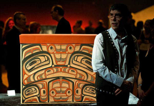 David A. Boxley stands next to the Tsimshian cedar bentwood chest that he made with his son,  Zach, at the Tináa Art Auction, a fundraiser for the Walter Soboleff Center, at Centennial Hall Feb. 1, 2014.