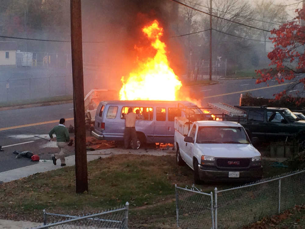 Flames rise from a vehicle following a fatal crash Sunday in Hyattsville, Maryland.