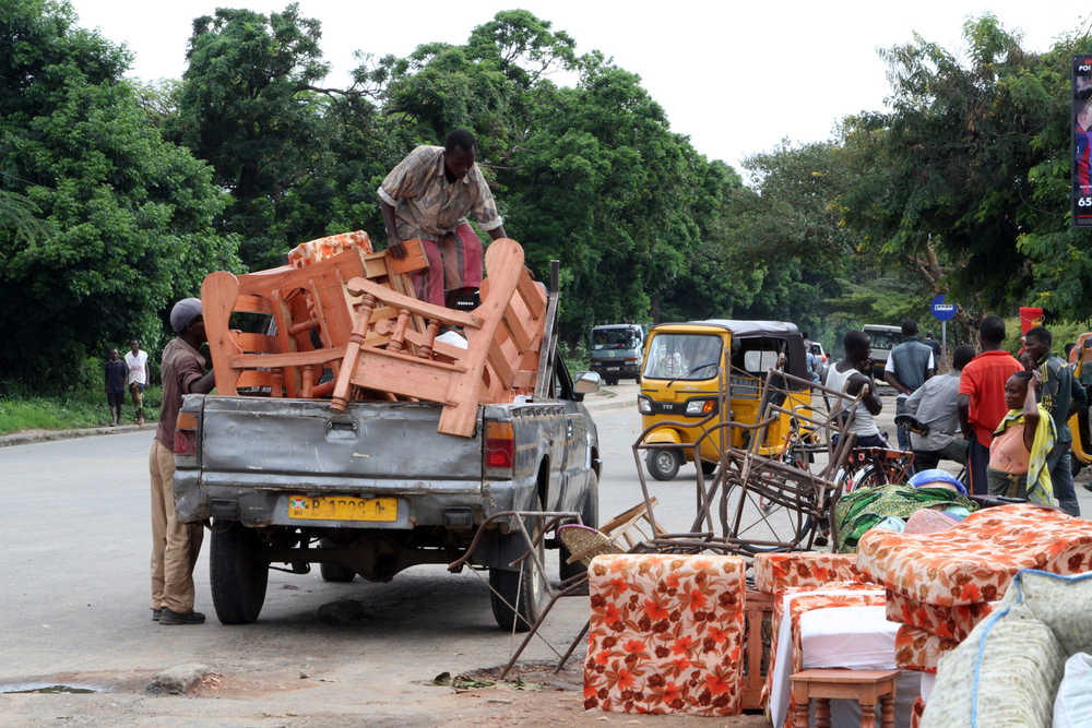 Burundians load belongings on a truck Saturday in Bujumbura, Burundi. Carrying their prized possessions, scores of people fled Burundi's capital Saturday before a looming security crackdown.
