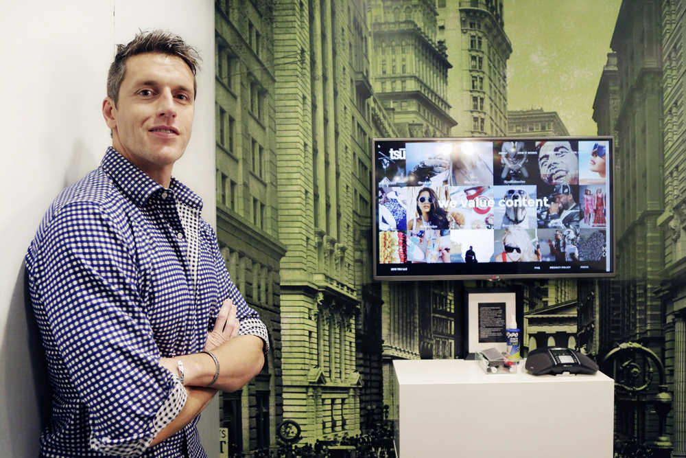 In this Nov. 4 photo, Sebastian Sobczak, CEO of Tsu.co, poses in his company's New York office. Tsu.co is winning converts to its social network by paying them for their posts. Facebook currently blocks all links from the smaller network, claiming they're low quality links that border on spam.