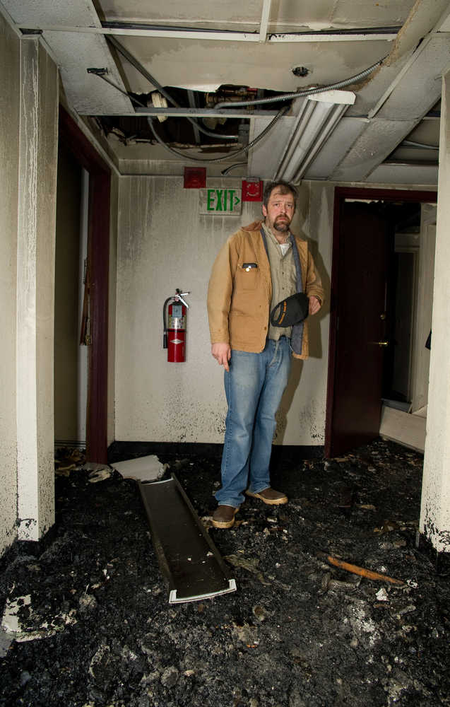 James Barrett, owner of the Gastineau Apartments, looks at damage in the third floor hallway of the Franklin Street building two days after a major fire on November 5, 2013.
