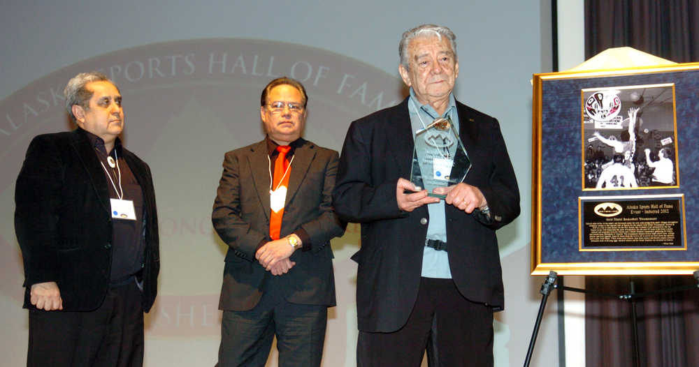 As Senator Albert Kookesh, representing Angoon, and Johan Dybdahl, representing Hoonah, look on, Sitka's Herb Didrickson holds the trophy awarded to the Gold Medal Basketball Tournament next to a portrait of the event during the 2012 Alaska Sports Hall of Fame induction ceremony at the Anchorage Museum. Didrickson was inducted the following year after a strong write-in campaign by fans and historians.