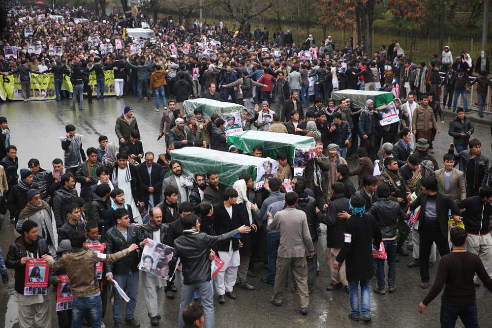 Protesters march through the Afghan capital of Kabul on Wednesday carrying the coffins of seven ethnic Hazaras who were allegedly killed by the Taliban and calling for a new government that can ensure security in the country.
