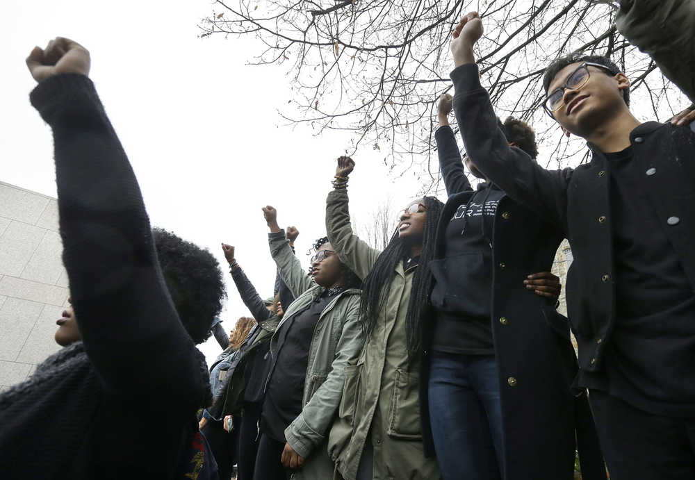 Students at Boston College raise their arms during a solidarity demonstration on the school's campus Thursday in Newton, Massachussetts. The protest was among numerous campus actions around the country following the racially charged strife at the University of Missouri.