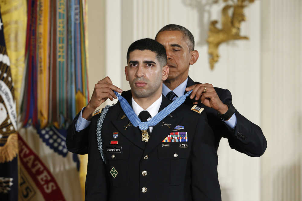 President Barack Obama bestows the nation's highest military honor, the Medal of Honor, to Florent Groberg during a ceremony in the East Room of the White House on Thursday.